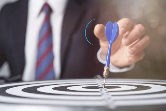 Dart hitting the bullseye, representing precise business goals