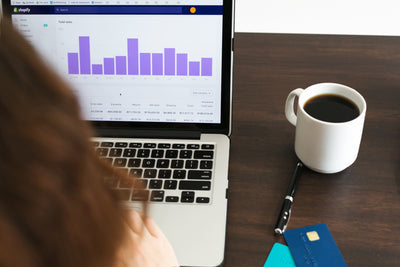 Reviewing sales data on a laptop