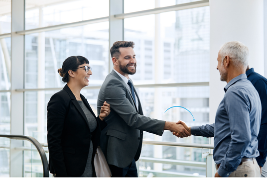 Business professionals shaking hands in a modern office