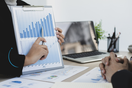 Business analytics charts reviewed on a laptop