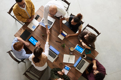 Business team collaborating around a laptop