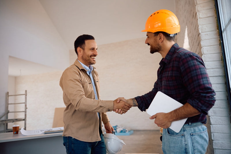 Contractor shaking hands with a construction worker