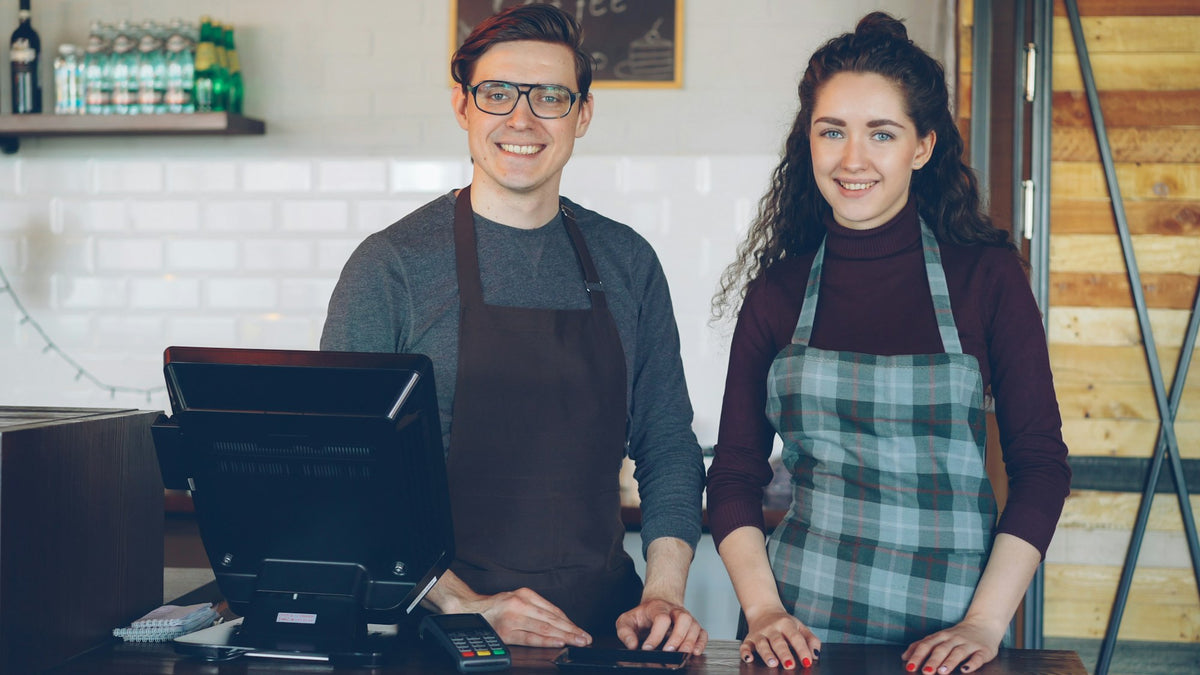 Independent cafe owners behind their counter
